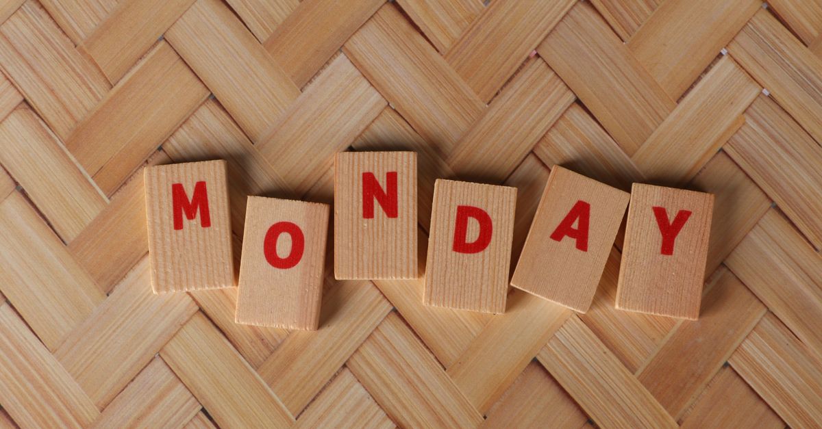 Wooden blocks spelling 'Monday' on a woven background, ideal for weekly content.